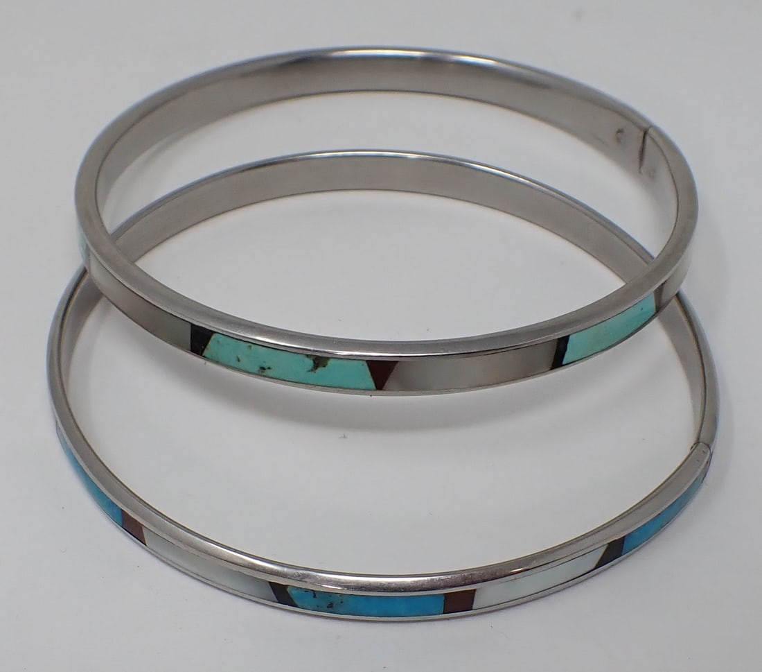 2 Inlaid Bangle Bracelets: Inlaid with turquoise and mother of pearl, silver-tone.