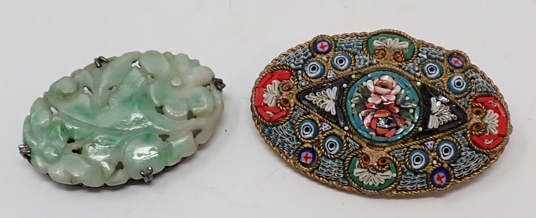 2 Oval Brooches: One sterling framed carved green jade; the other is a large micro-mosaic with brass backing.