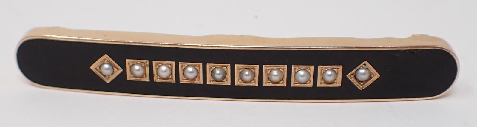 Victorian Black Onyx and Pearl Bar Pin Pendant: 14K yellow gold large oblong pin pendant with 10 seed pearls within black onyx, some damage to onyx, approx. 2.75" in length, 5.1 dwt.