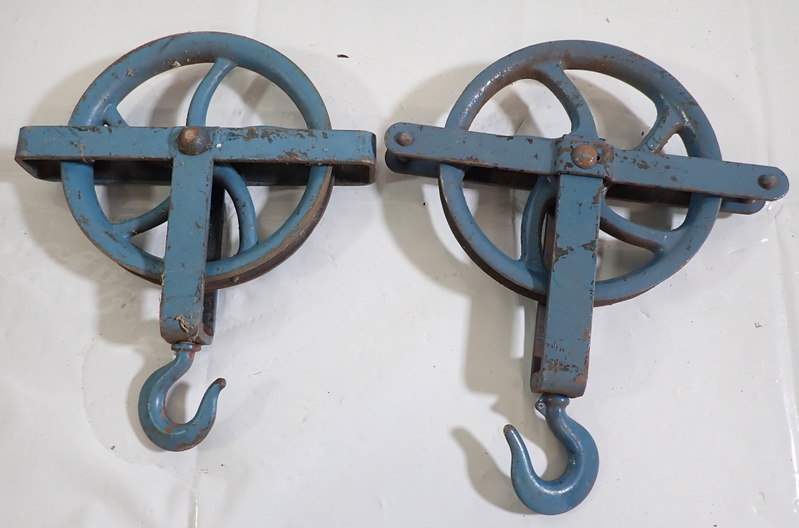2 Iron Pulleys: Wheel are apprx 10" in diameter. Right one is approx 17" long