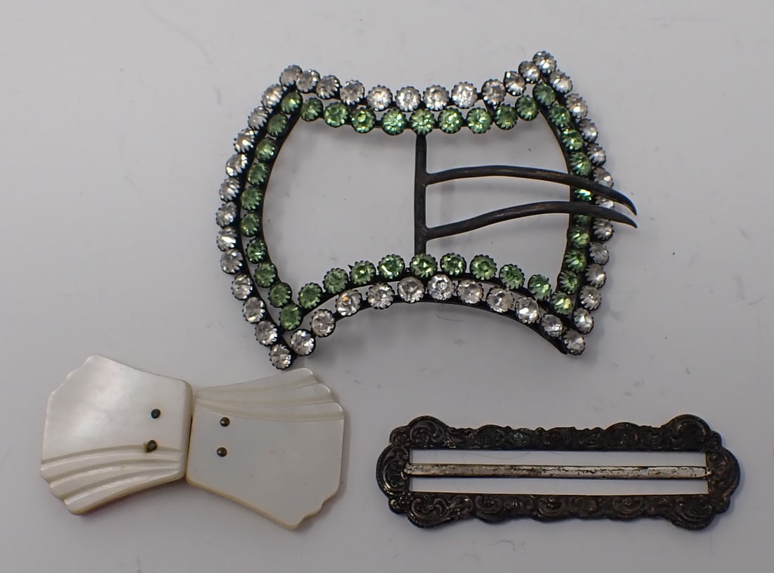 3 Vintage Belt Buckles: Includes a 2-piece mother of pearl buckle; silver-tone repousse style; and a large green and clear rhinestone buckle.