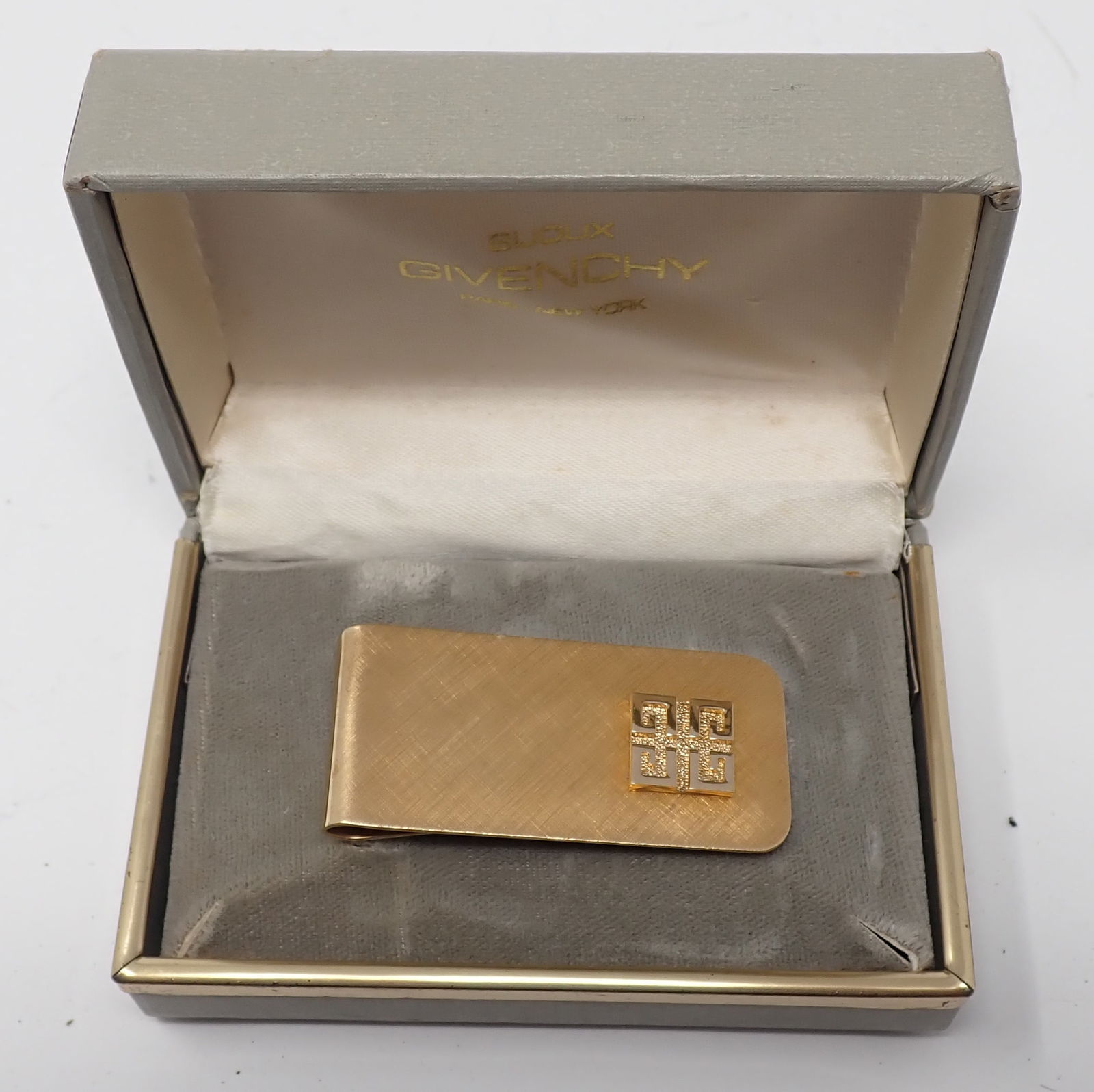 Givenchy Money Clip: Gold-tone clip with applied Givenchy logo, housed in original Givenchy gift box.