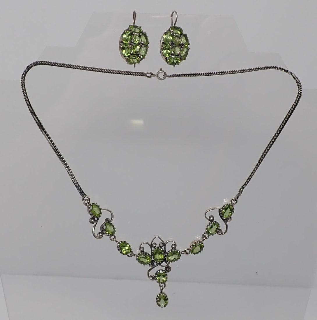 Peridot Cluster Necklace and Earrings: Sterling braided chain with center 11 peridot decoration, each is approx. 8mm x 6mm; along with a pair of earrings covered with oval and round cuts, 0.99 ozt total.