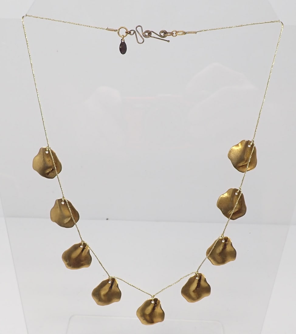 Lee Angel Necklace: Gold-tone string necklace with 9 gold-tone freeform shapes, with metal tag of Lee Angel. approx. 21"