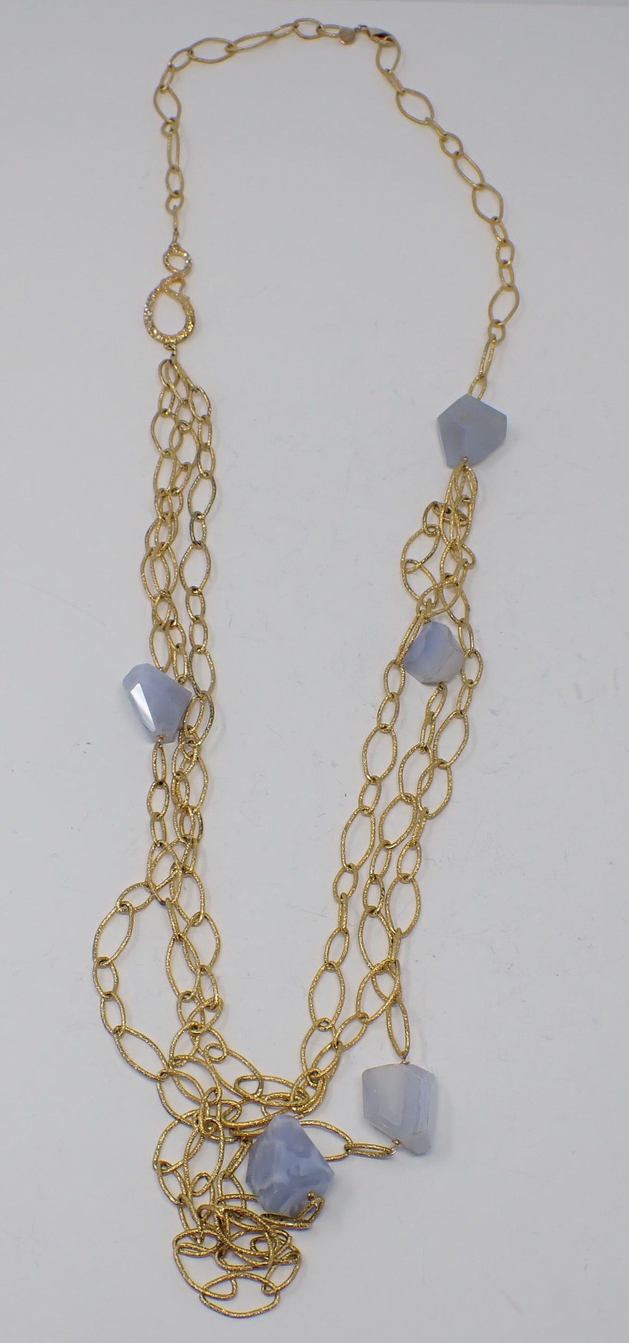 Alexis Bittar Necklace: Single strand into three strand long gold-tone necklace with 5 scattered freeform faceted ice blue agate beads. overall approx. 46" in length.