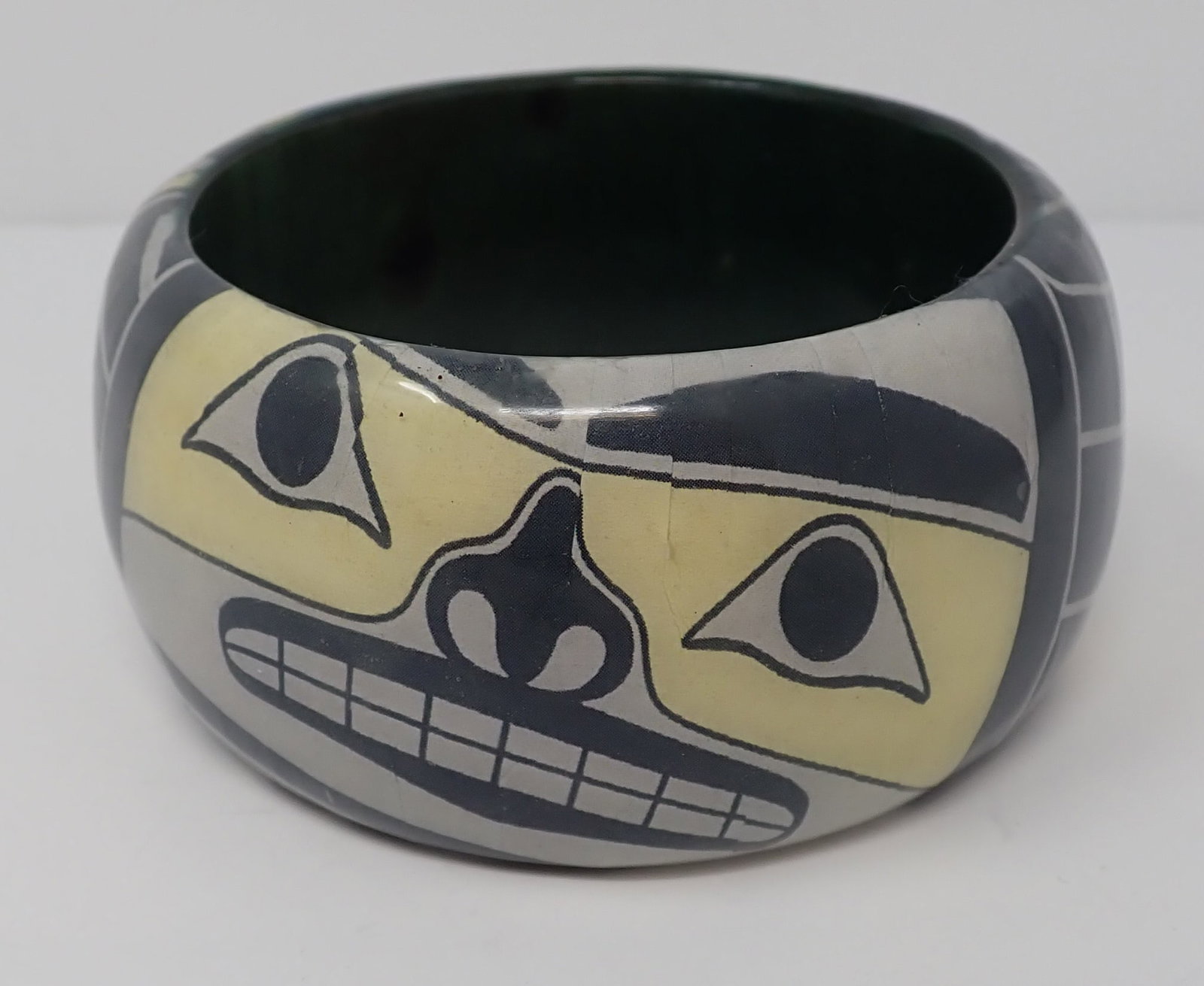 Wood based Bangle with Face: Marked "Chilkat by T.J. Young, Haida, approx. 1.75" wide
