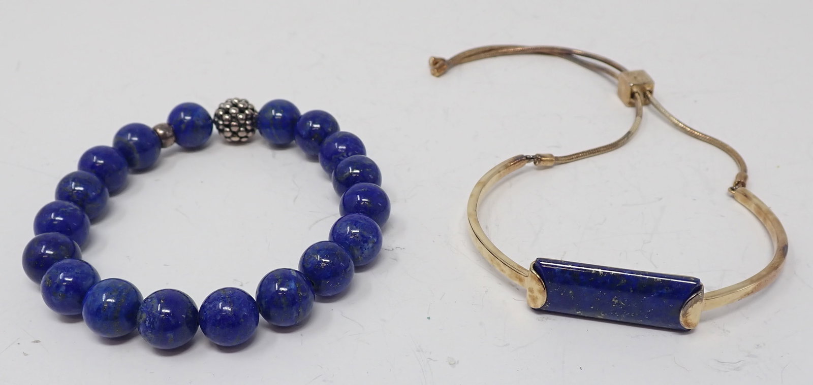 2 Lapis Bracelets: Lagos caviar bead and 10mm lapis beads; along with a vermeil cuff with drawstring containing a long rectangular lapis cabochon