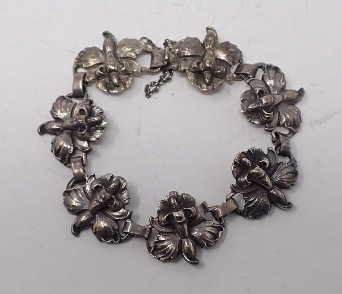 Cini Sterling Floral Bracelet: Consists of 7 orchid shaped links, approx. 8" long, safety chain, 0.85 ozt.