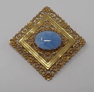 Miriam Haskell Brooch: Gold tone square brooch centered with a glass blue star stone, approx. 1.5" square.