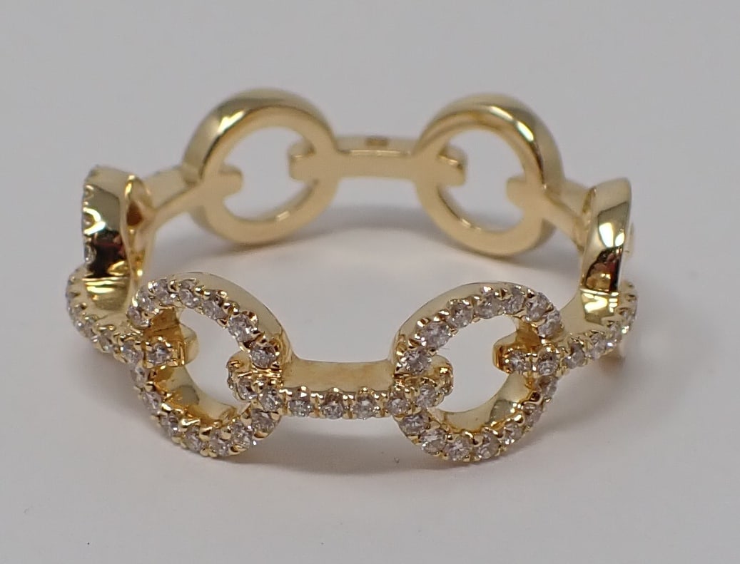 Gold and Diamond Ring: 18K yellow gold with rolo link motif, accented with many diamonds covering the top half of the ring, marked with an N, ring size 7-1/2, 2.39 dwt.