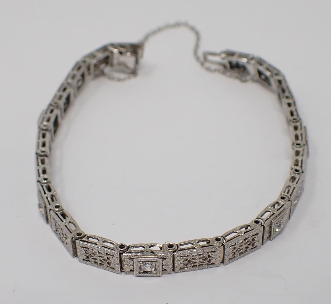 Gold Filigree and Diamond Bracelet: 14K white gold filigree bracelet containing 5 full cut bead set diamond accents, 6.5" length, security chain, damage to clasp, 5.40 dwt.