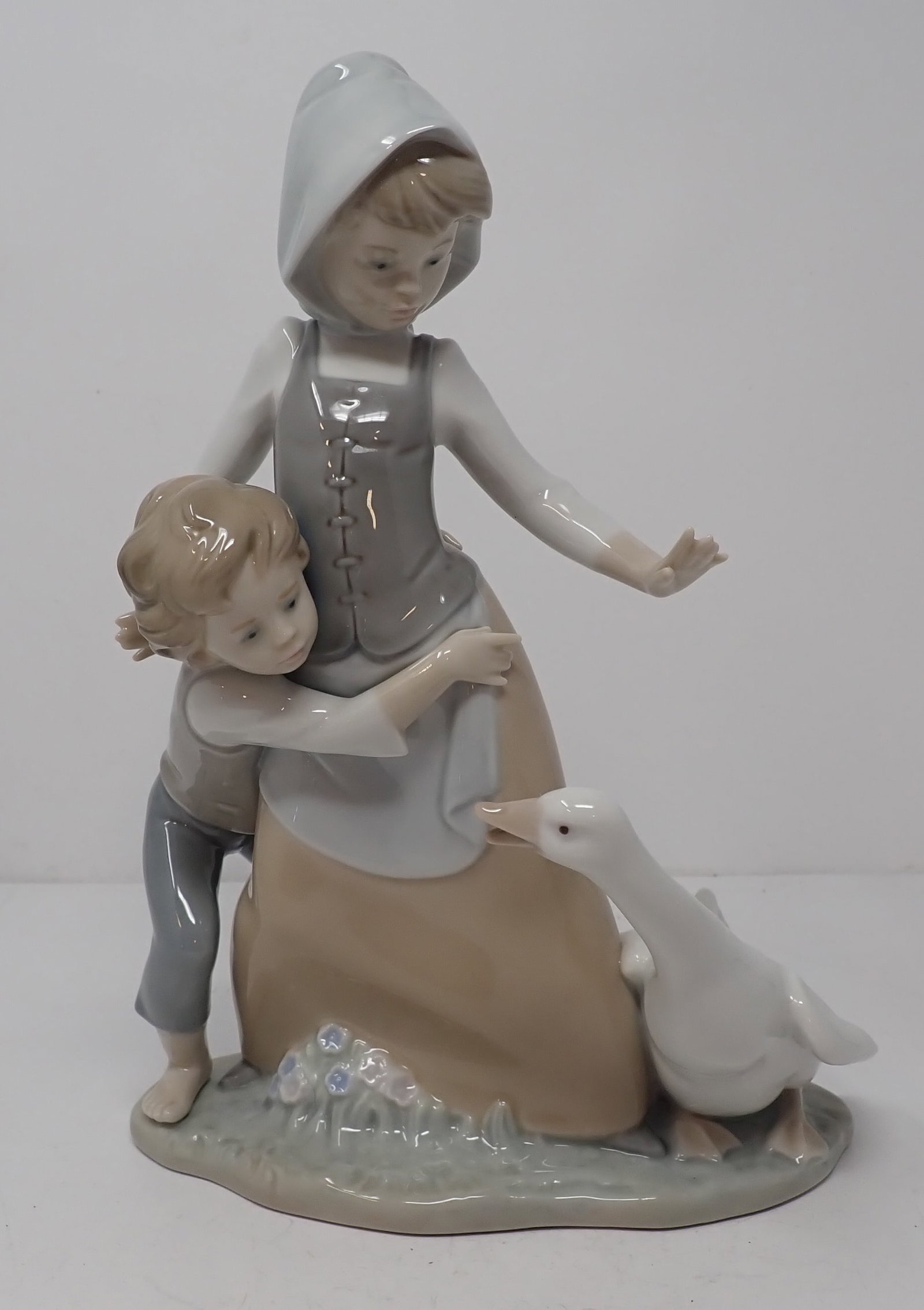 Lladro Girl & Boy w/ Goose: Apprx 10" tall. Shipping available