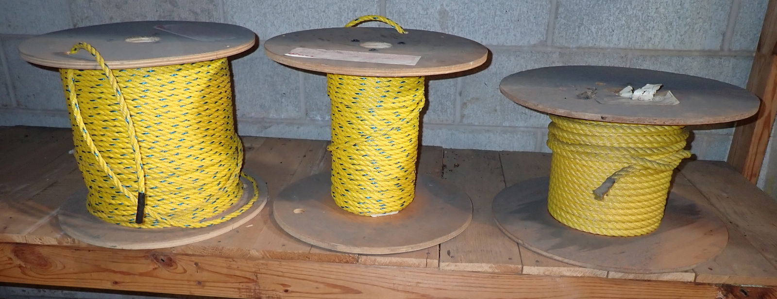 3/8" & 1/2" Rope: Guessing , roll on left has approx 600'. Tag says a full spool is 1200 feet. 2 Spools on left are 3/8". No in house shipping