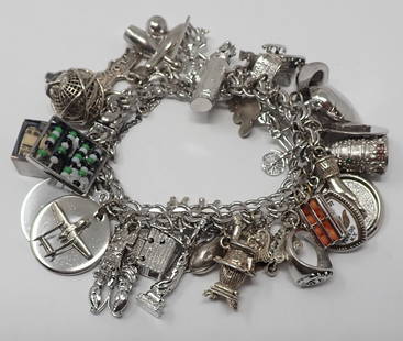 Charm Bracelet: White gold-filled double curb link bracelet with 33 various sterling and silver-tone charms.