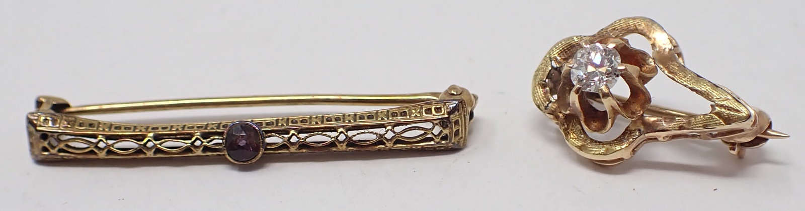 2 Gold Lingerie Pins: Both 14K yellow gold including one filigree bar pin with amethyst (bent); and one oblong with a buttercup setting holding an old mine cut diamond accent, 1.52 dwt total.