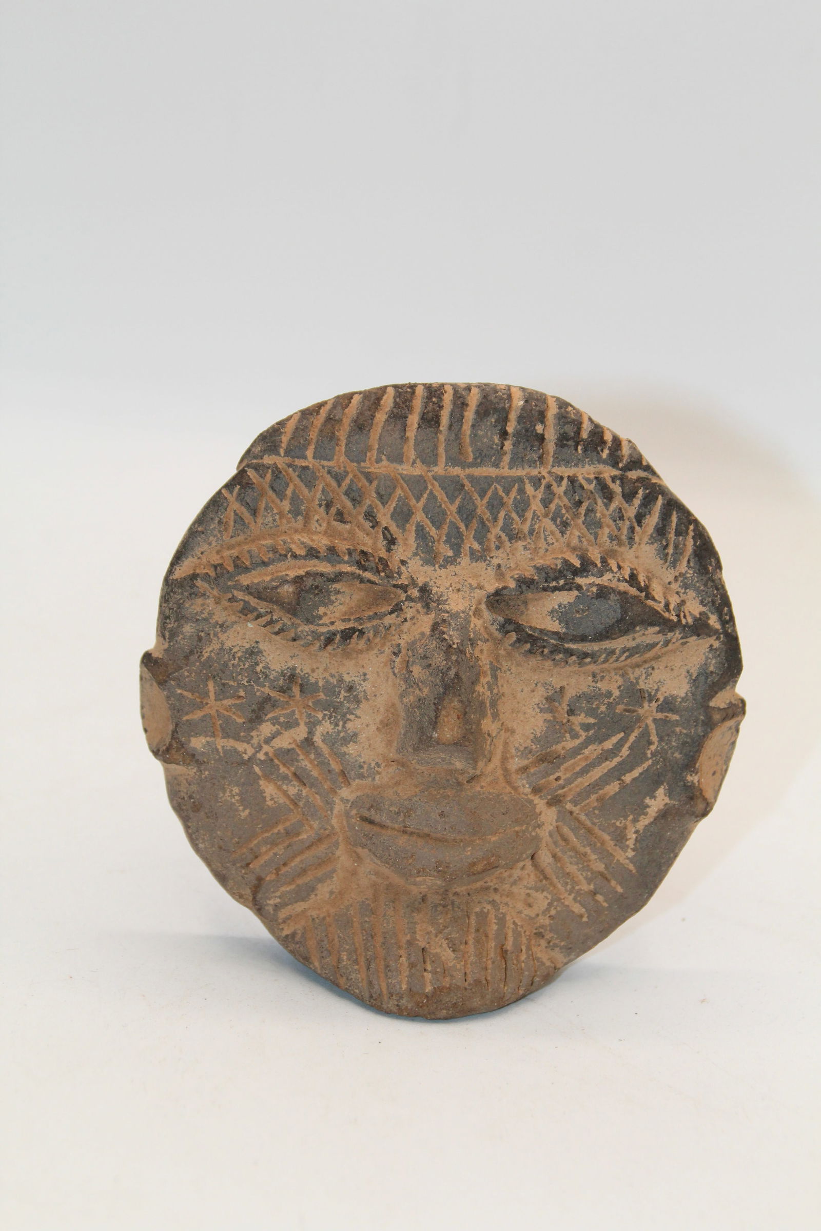 Sumba Mask African Clay: Apprx 4" in diameter. Shipping available
