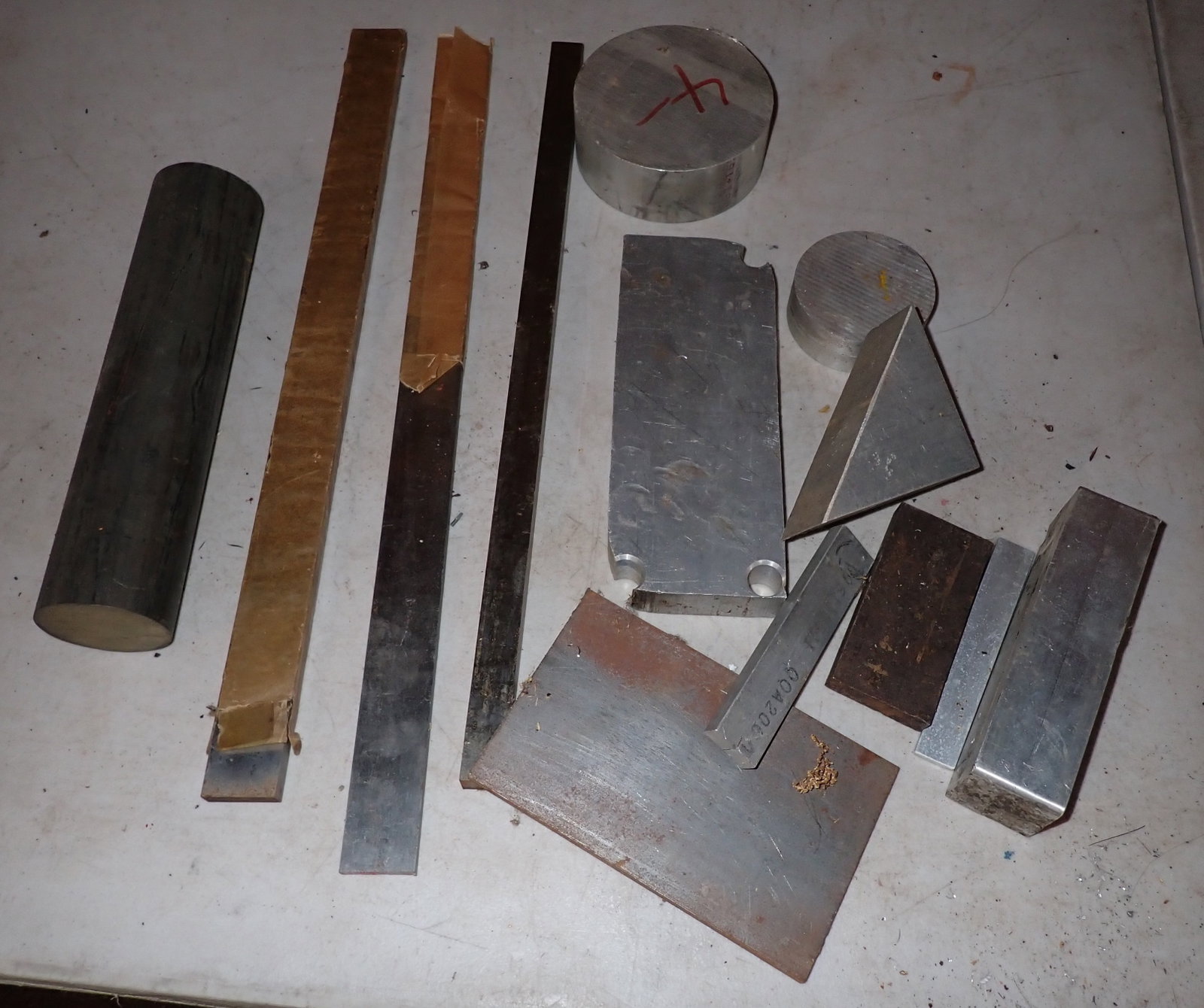 Steel & Aluminum Stock: Piece of steel on left is approx 2 1/4" in diameter and 9 7/8" long. No in house shipping