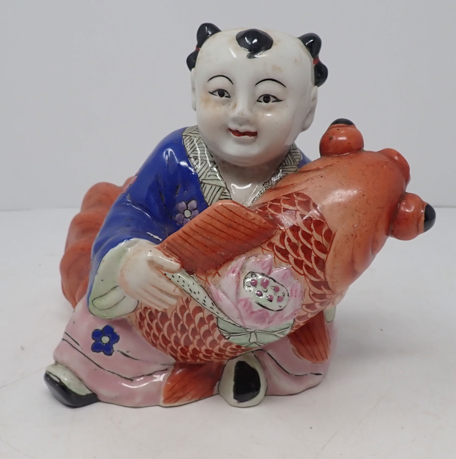 Chinese Ceramic Figure w/ Koi: Approx 6 1/4" tall. Shipping available