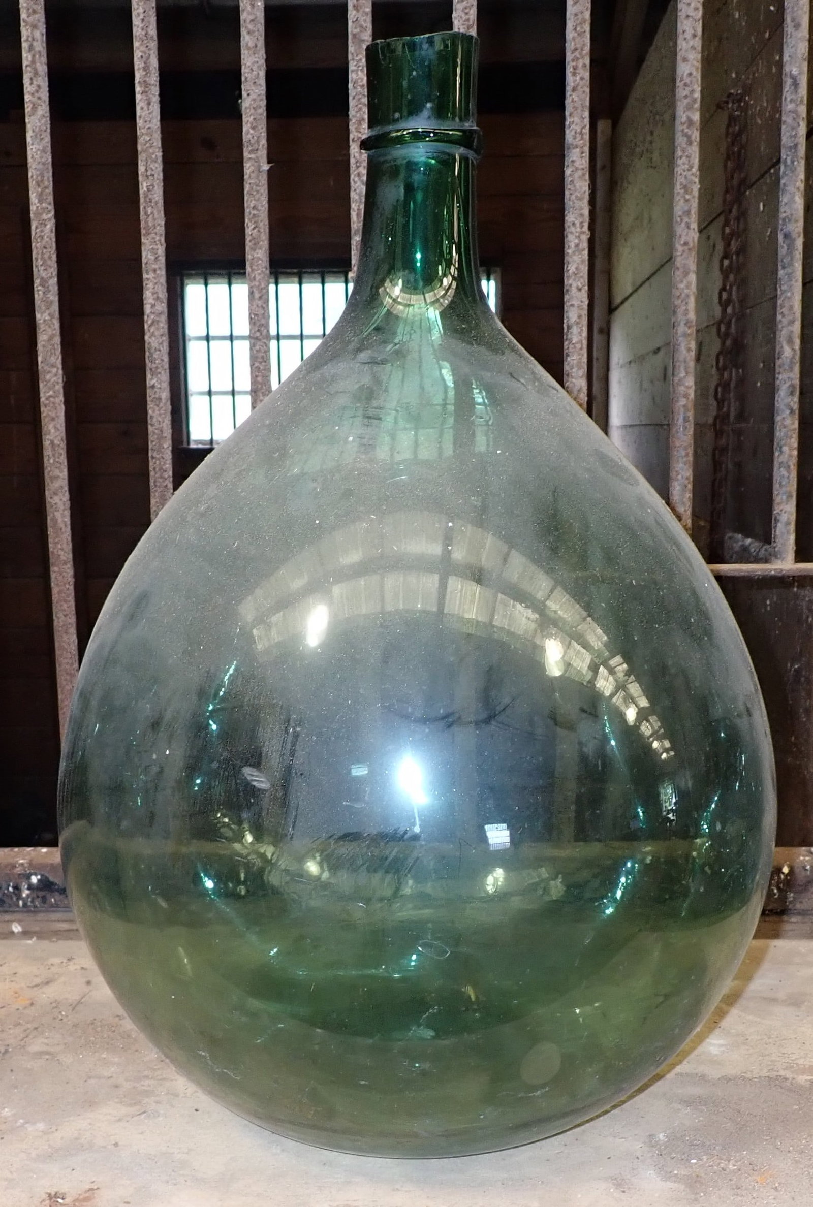 Demijohn Bottle: Approx 14" in diameter and 22" tall. Has lots of air bubbles in glass. No in house shipping !