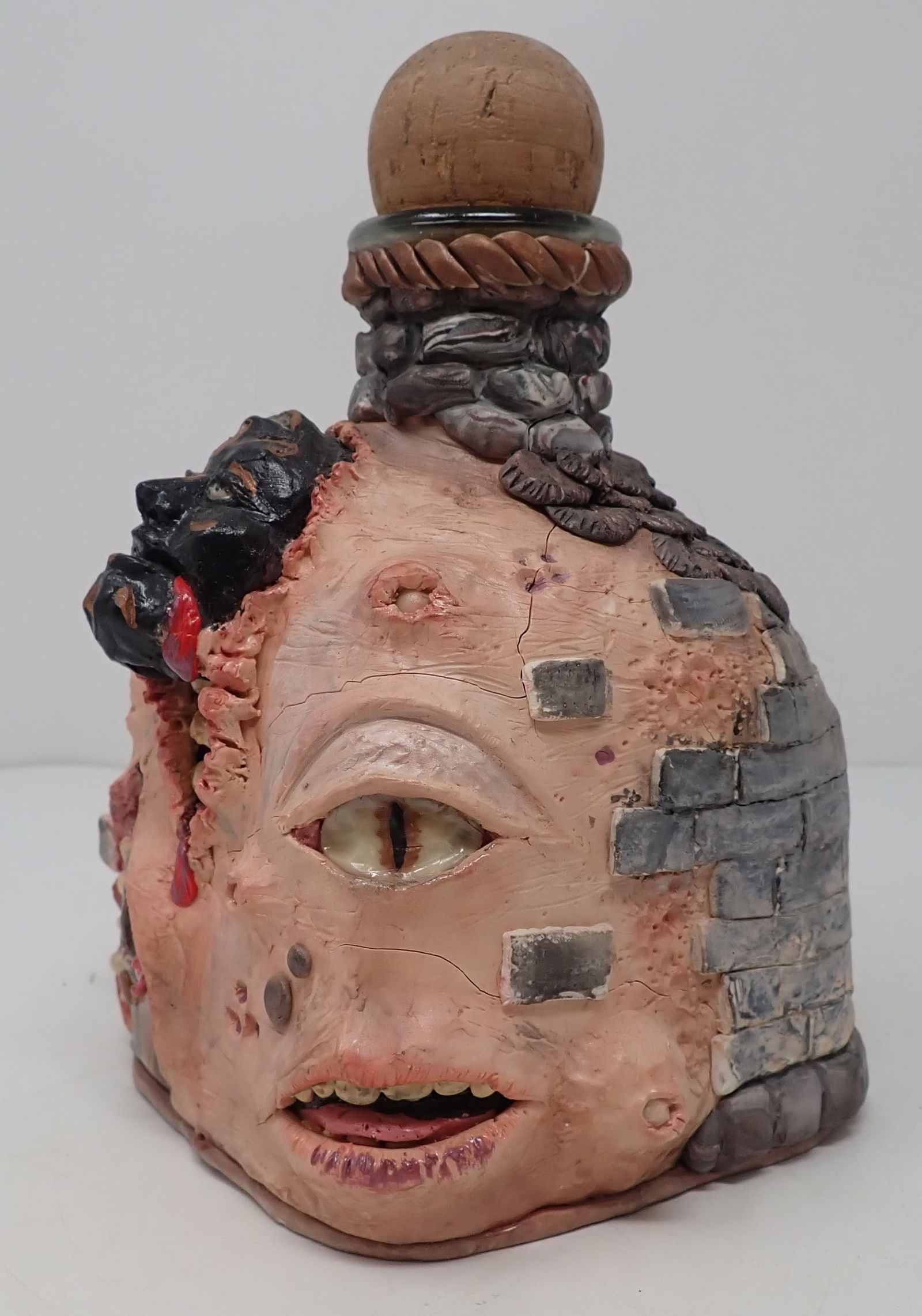 Grotesque Face Decanter: Seems to be clay over glass. Approx 7 3/4" tall. Shipping available