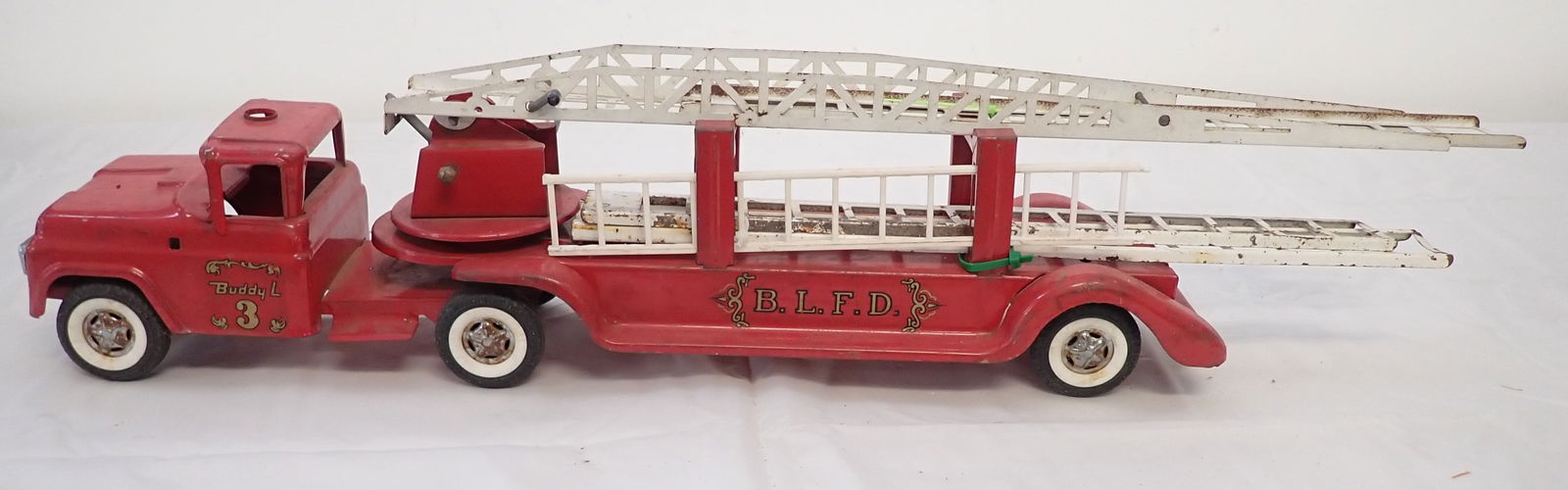 Buddy L 3 Firetruck: Apprx 32" long. One of the ladders hanging on the side is plastic. Shipping available ($20 handling charge, plus postage)