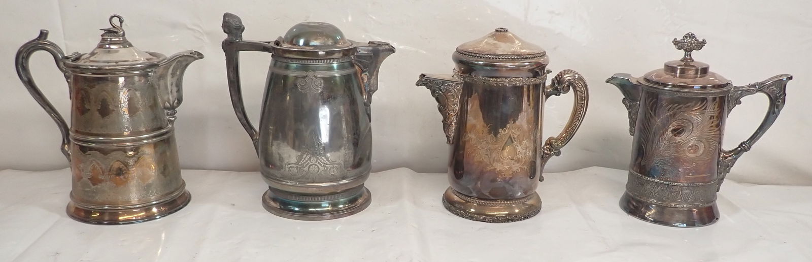 4 Silverplate Coffee Pots: Tallest is apprx 11 3/4". Shipping available ($20 handling charge, plus postage)