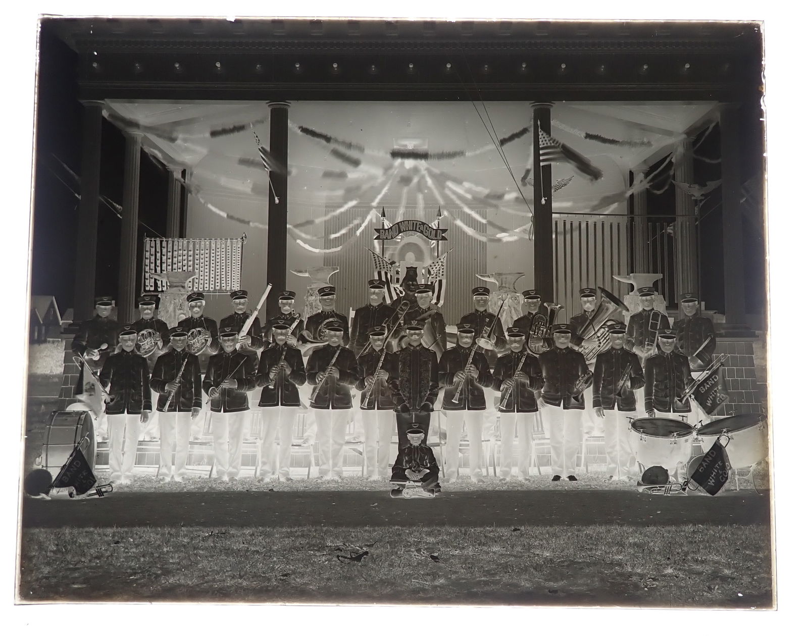 Max Schmidt's Band White & Gold Glass Negative: Long Branch Band negative with 4 Anvils in background on stage and Winchester Cannon in front of little boy. Approx 8" x 10". Shipping available