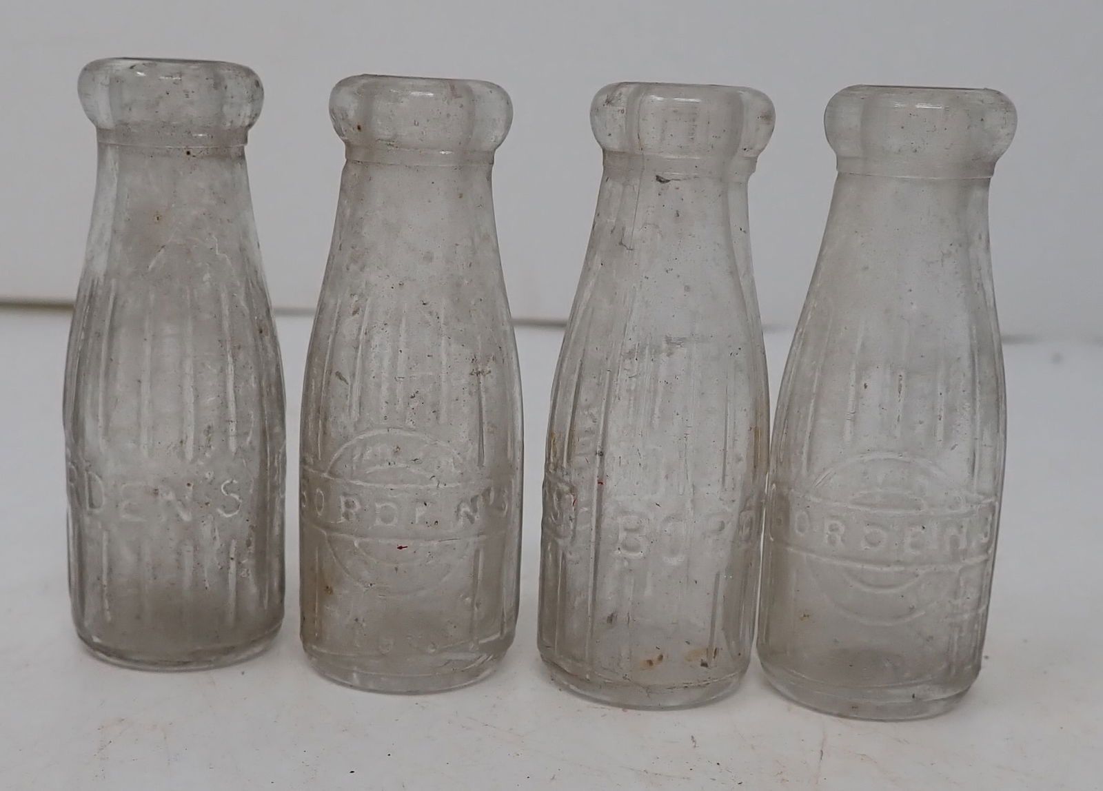 Miniature Glass Bordens Milk Bottles: Approx 2 3/4" tall. Shipping available