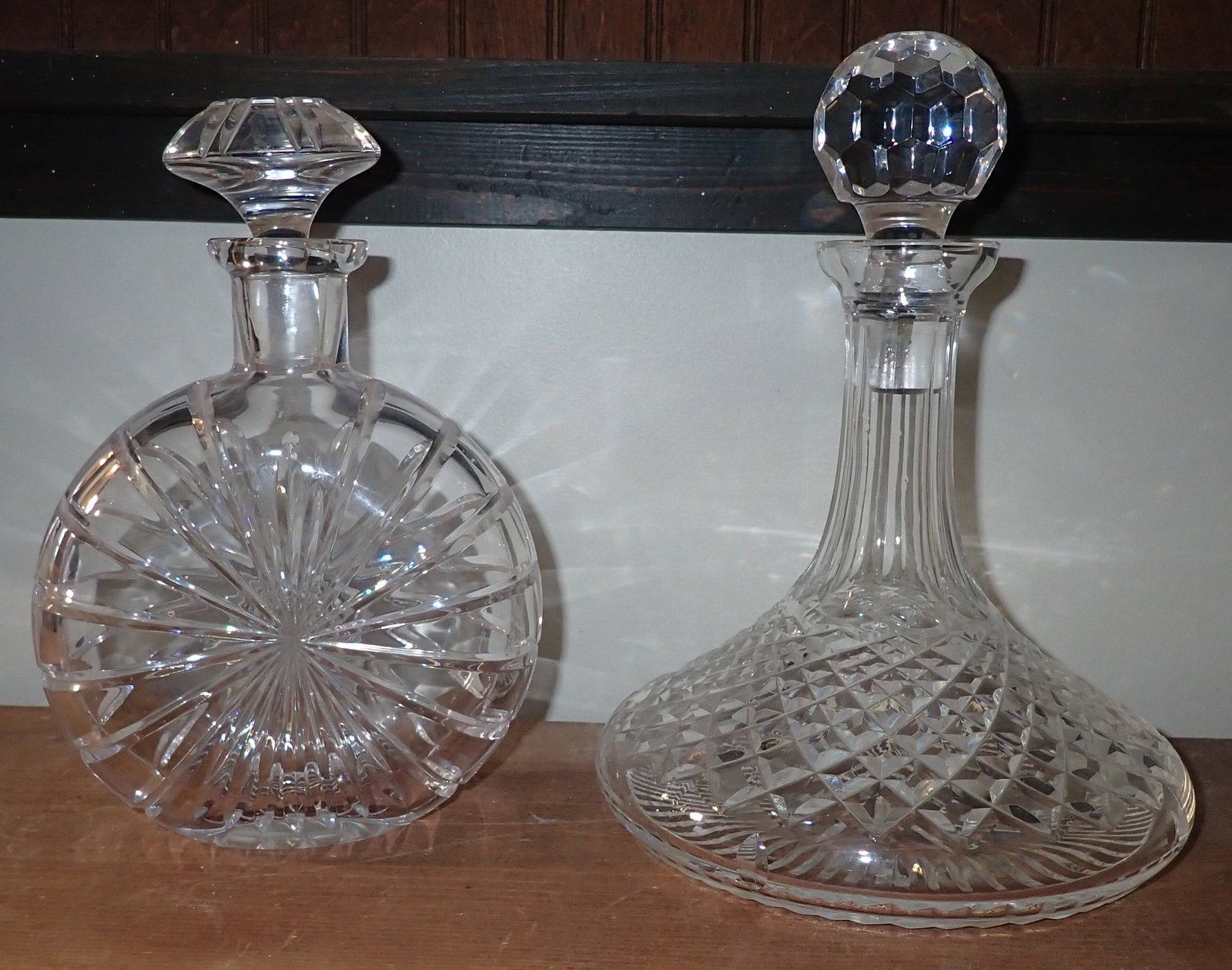 2 Crystal Decanters: Right one is apprx 7" in diameter and 10" tall. Seems like the stopper on the left one is not correct. Shipping available.