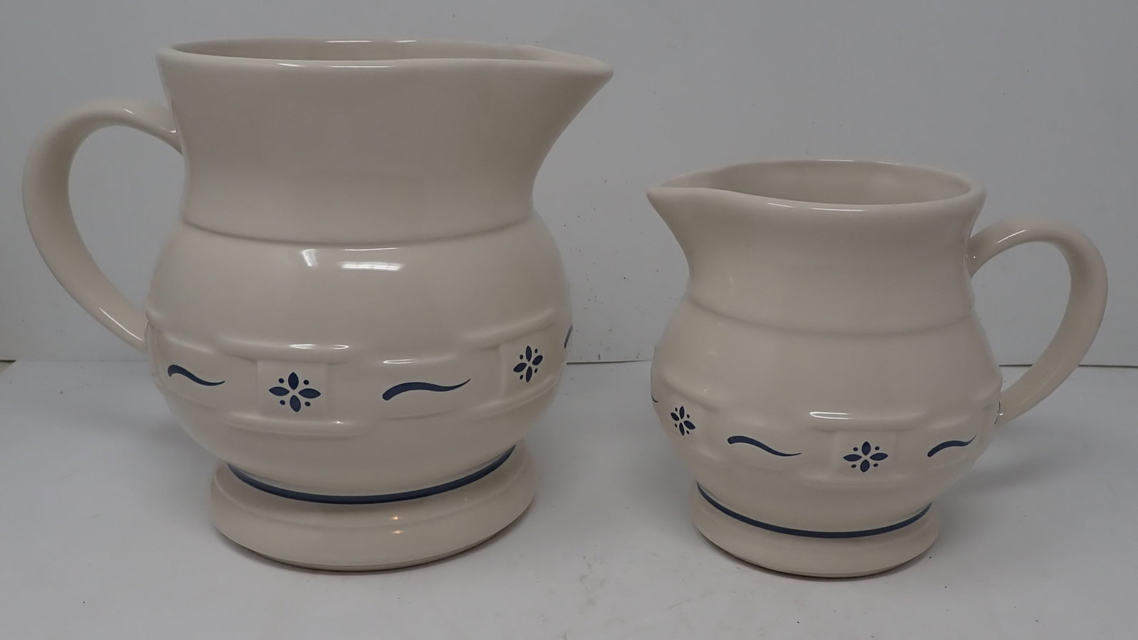 2 Longaberger Pottery Pitchers: Tallest is approx 7 1/4" tall. Shipping available ($15 handling charge, plus postage)