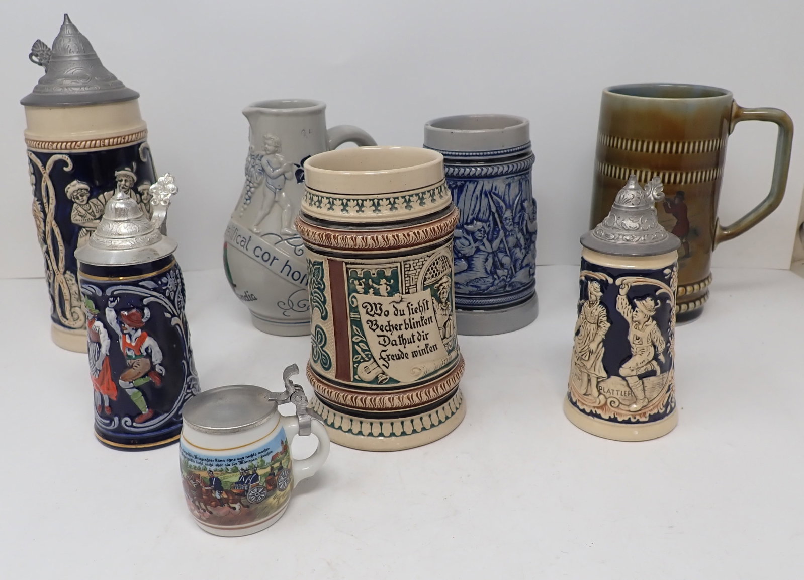 German Steins & Pitcher: Tallest is approx 8 3/4" tall. Shipping available ($20 handling charge, plus postage)