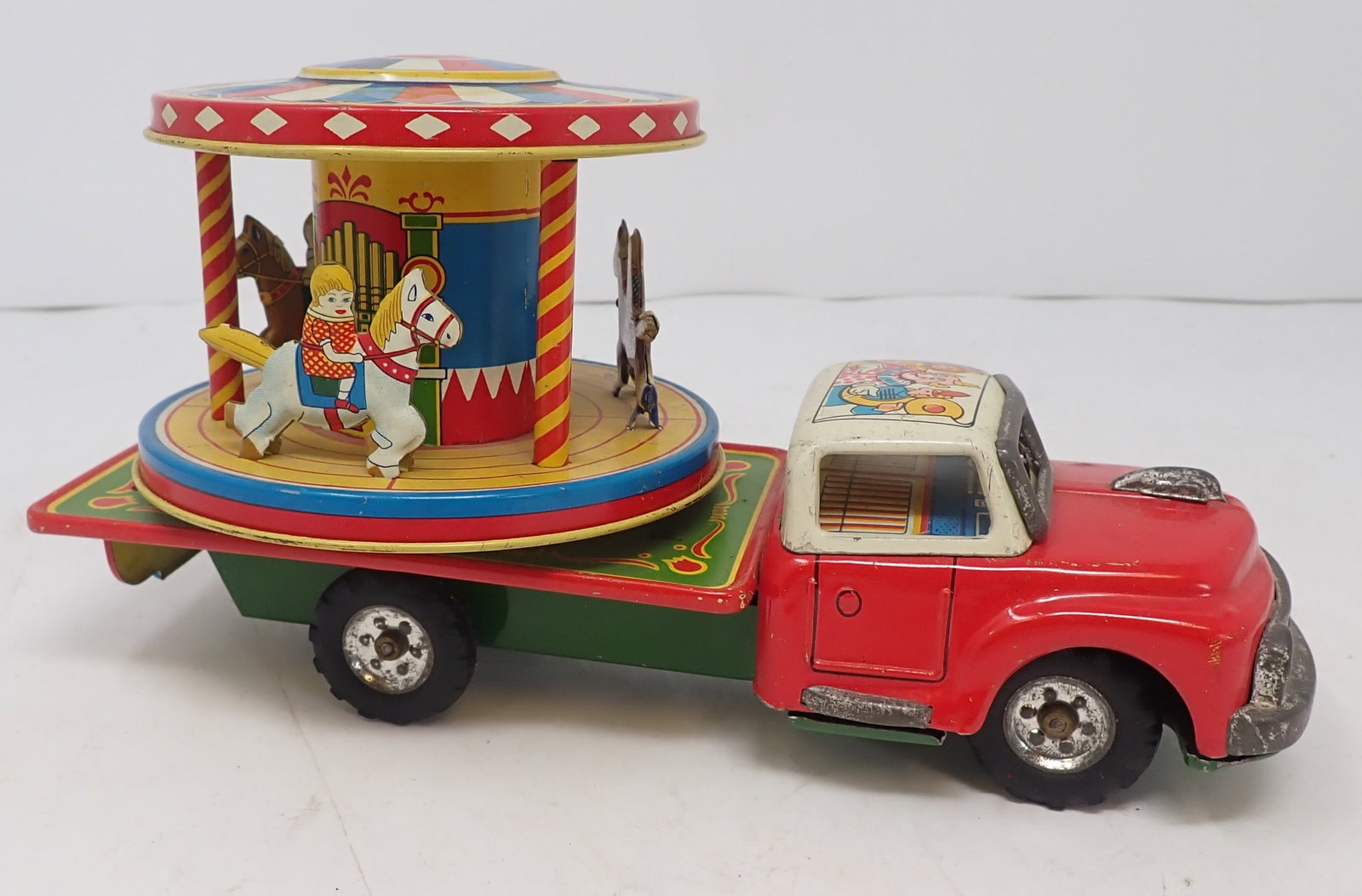 Friction Tin Litho Merry Go Round Truck & Top: Approx 8" long. Shipping available