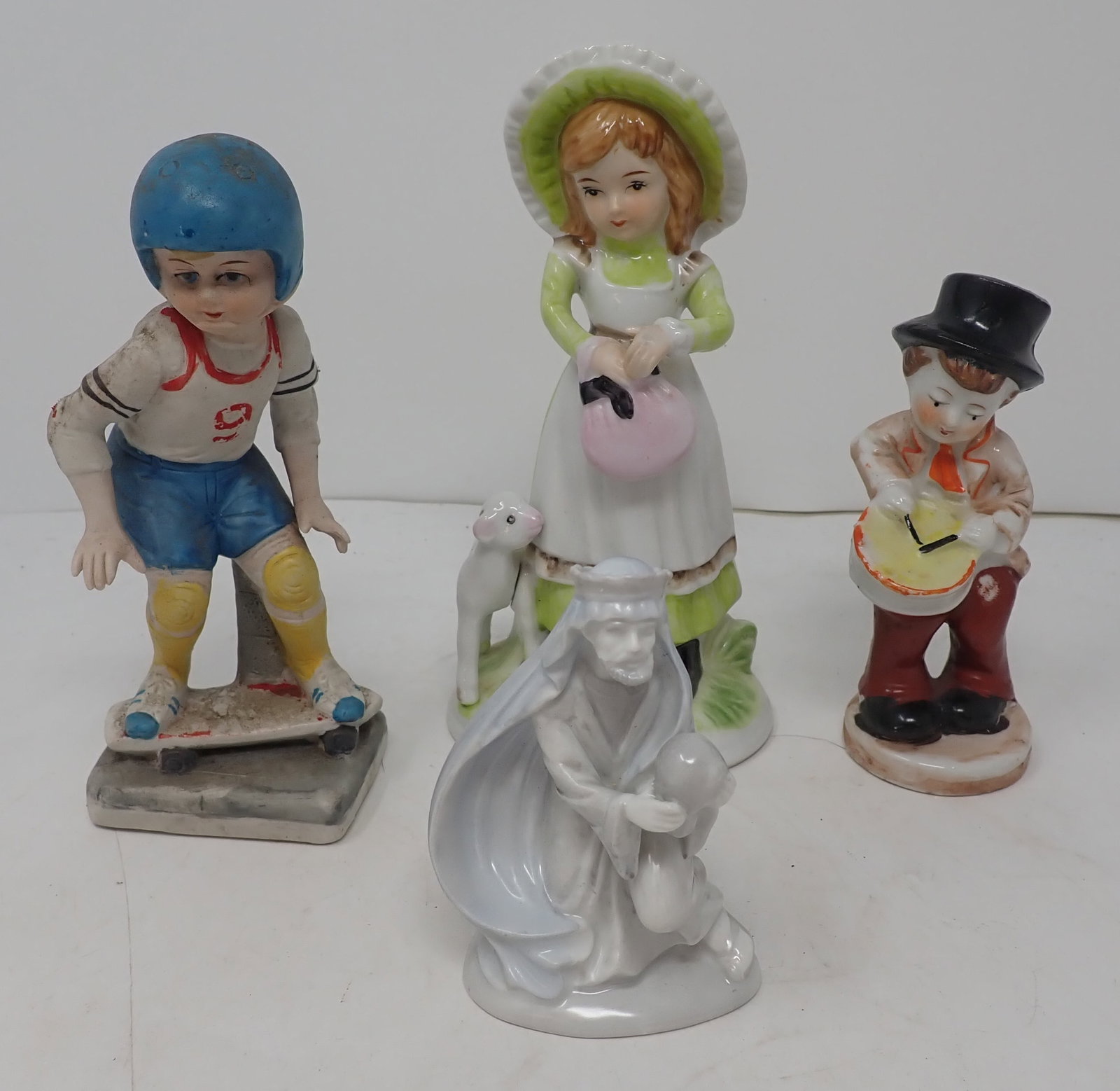 4 Figurines: Tallest is approx 6 5/8" tall. Shipping available