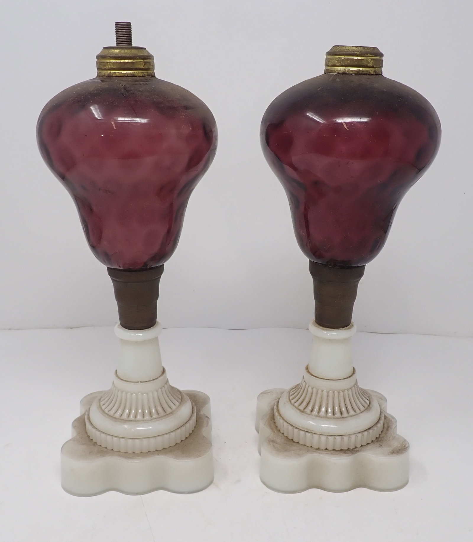 Pair of Deep Cranberry Oil Lamps w/ Milk Glass Bases: Approx 4" in diameter and 11 1/4" tall. Shipping available