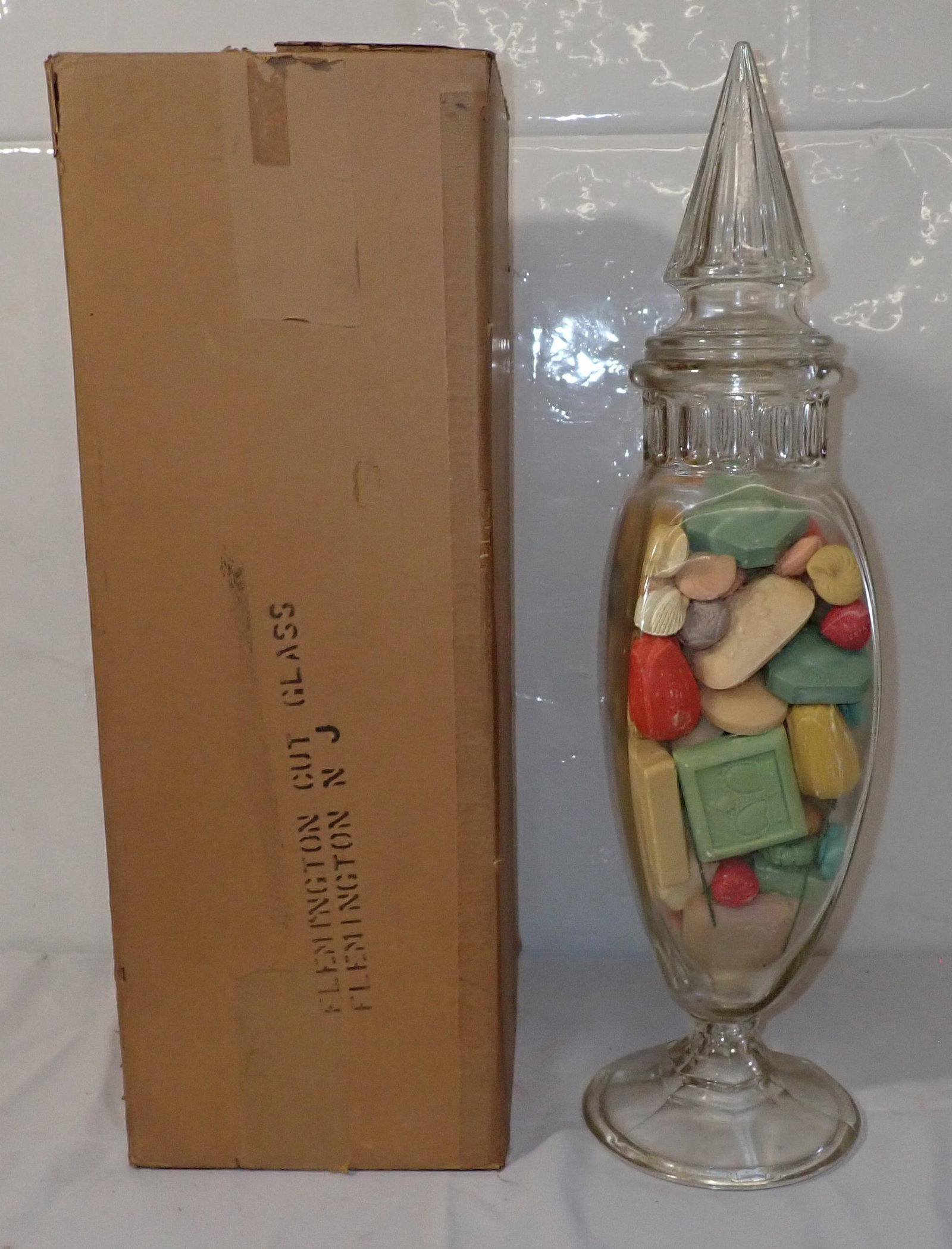 Large Apothecary Jar w/ Original Box: Approx 7" in diameter at base and 26" tall. Filled with soap. Shipping available ($30 handling charge, plus postage)