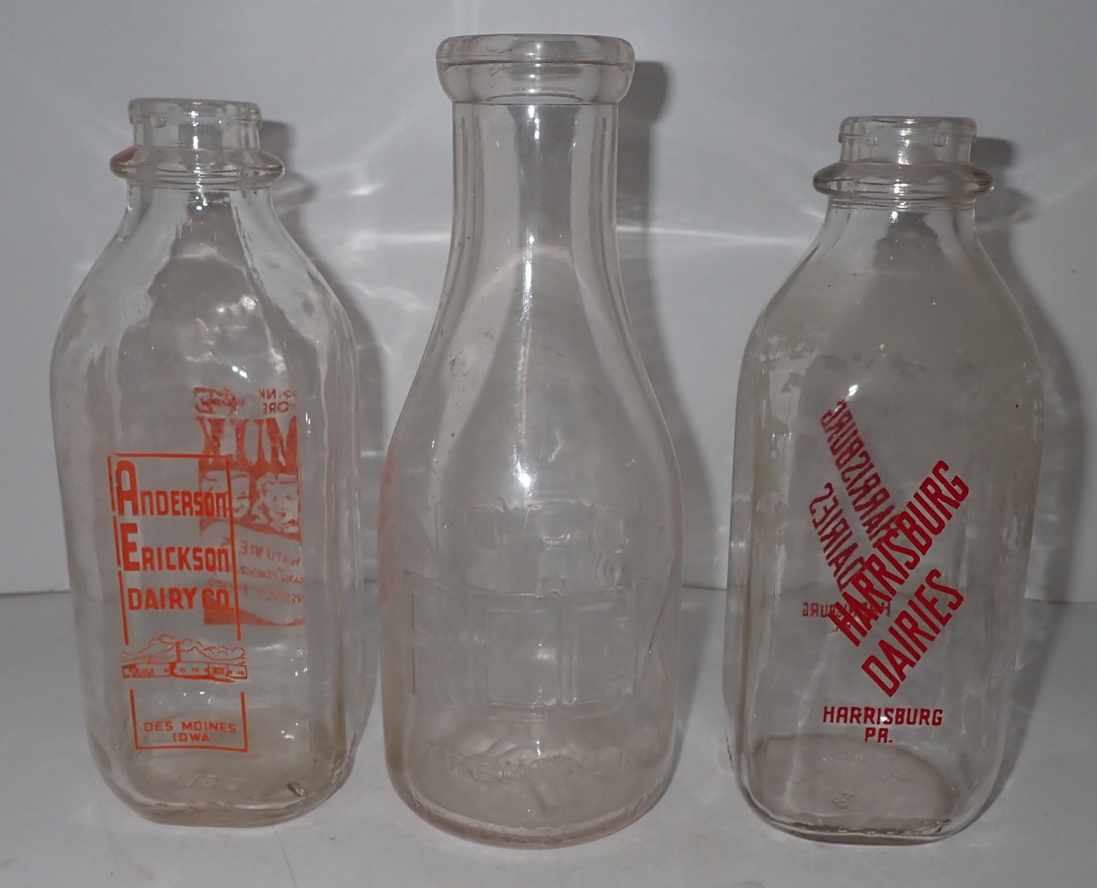 Trenton, Iowa , & Harrisburg Milk Bottles: Tallest is approx 9 5/8" tall. Shipping available