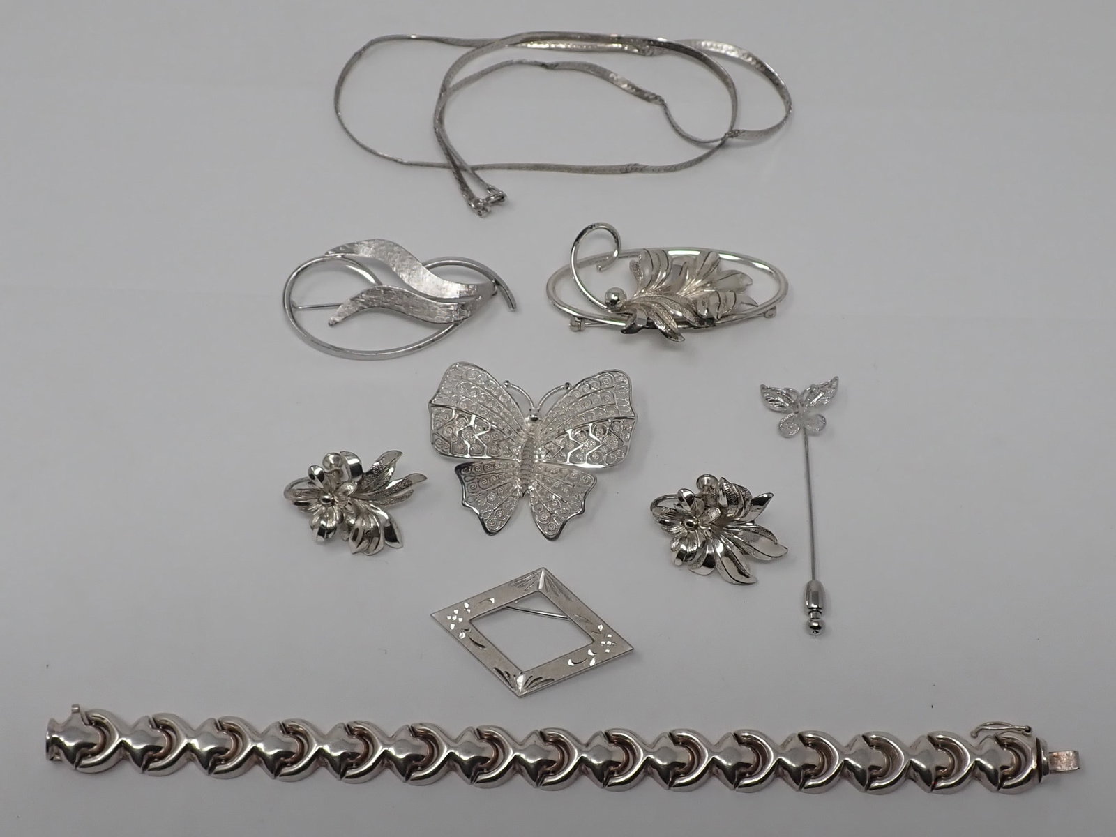 Sterling Silver Earrings, Bracelet, Butterfy Brooch: All are marked Sterling or 925. Bracelet is approx 7 1/2" total length. Total weight of all is approx 35.89 dwt. Shipping available