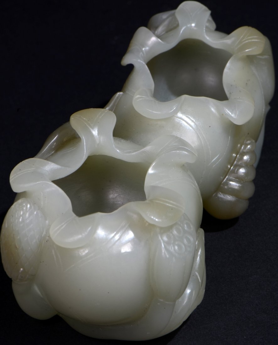 A Light Celadon Jade (Nephrite) Lotus Brush Washer: Mid. 20th c.; 9.5x4x3.5 cm.; 116.5g; Specific Gravity(SG): 2.95; This exquisitely carved light celadon Jade lotus brush washer is formed from dual lotus blossoms. A realistic cut lotus branch with det
