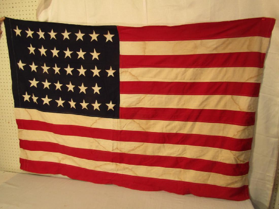 36 STAR AMERICAN FLAG CIVIL WAR: Attributed Civil War era 36 star American flag, old fabric label #27 Civil War flag. 66 x 44 inches. Some scattered stains otherwise good condition.