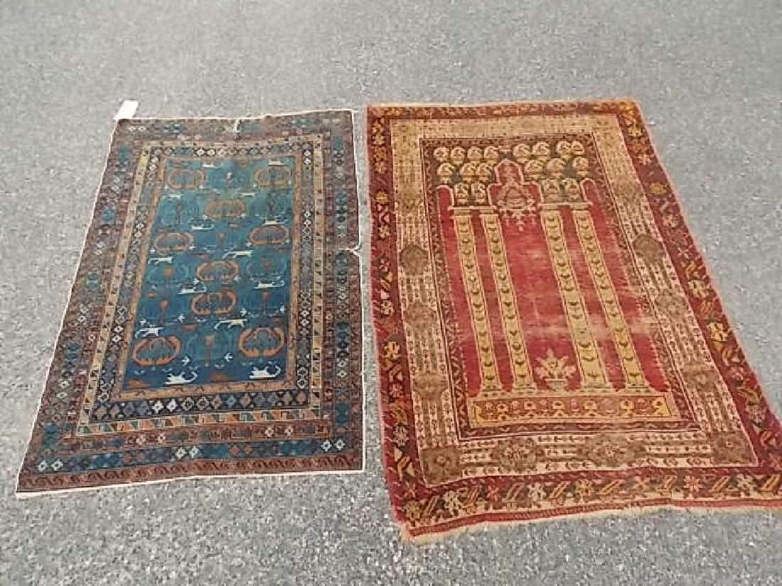 2 ANTIQUE CAUCASIAN RUGS: Includes red prayer rug 3 ft 8 x 5 ft (much wear) and a blue rug with a few tears 4 ft 7 x 3 ft. Sold as is.