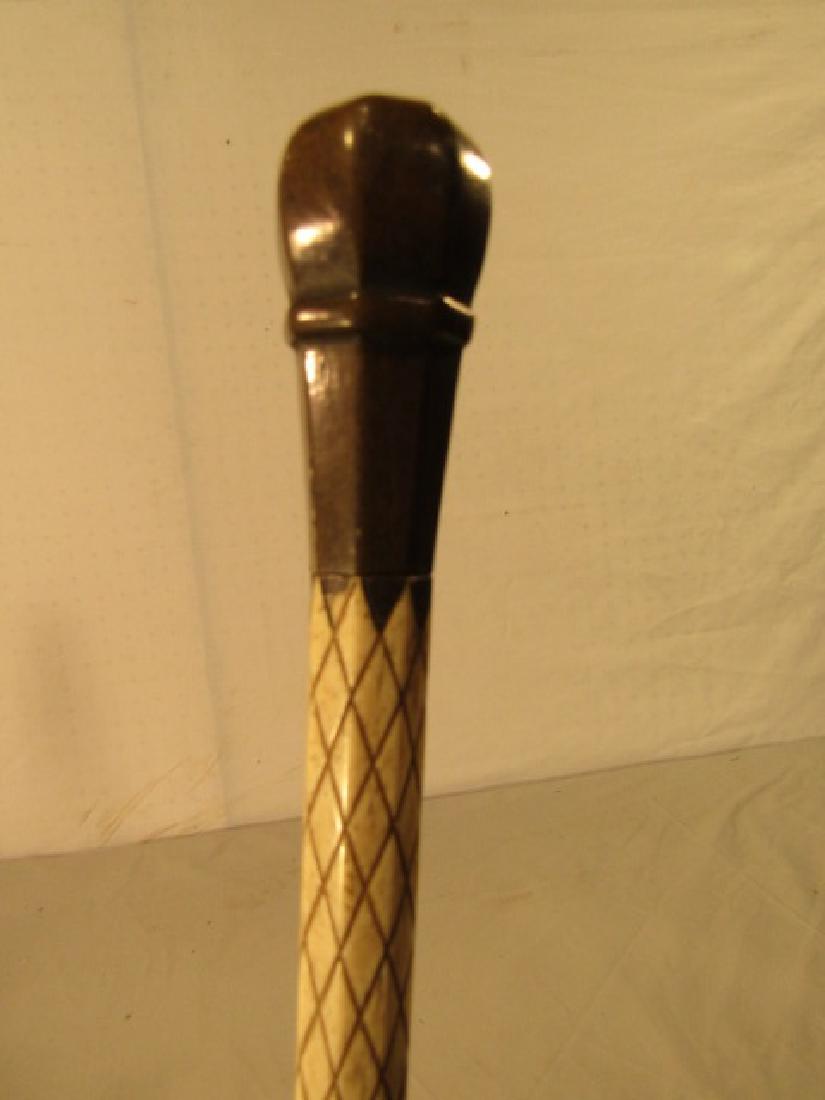 WHALE BONE CAPTAINS CANE: Fine antique whale bone captain's cane with painted octagonal knob and hatchure carved shaft. 35.5 in long.