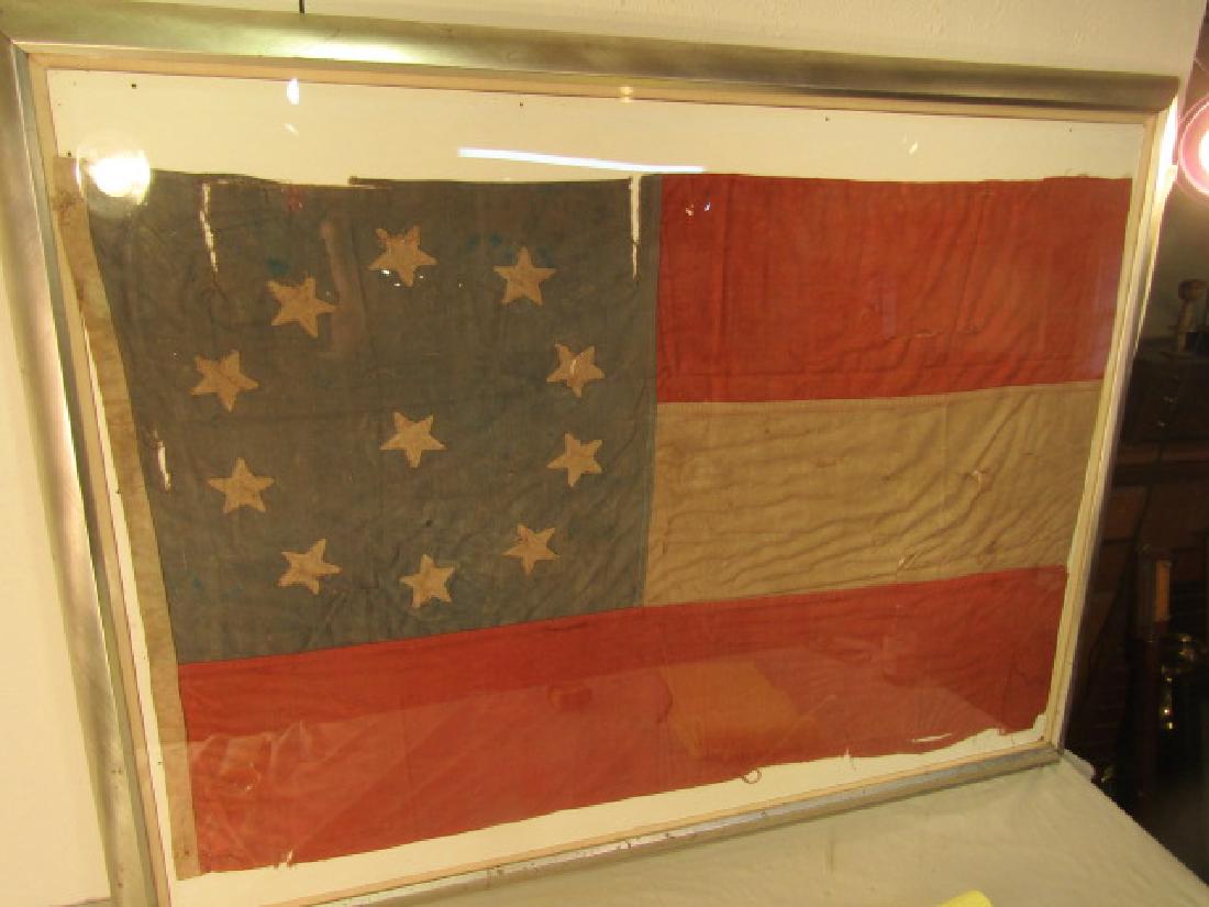 CONFEDERATE REUNION FLAG 11 STARS: Antique Confederate reunion flag with 11 stars and 3 stripes. Machine stitched cotton and linen. 52 x 33 in (framed 58 x 44). Some tears. Can be shipped without heavy frame.