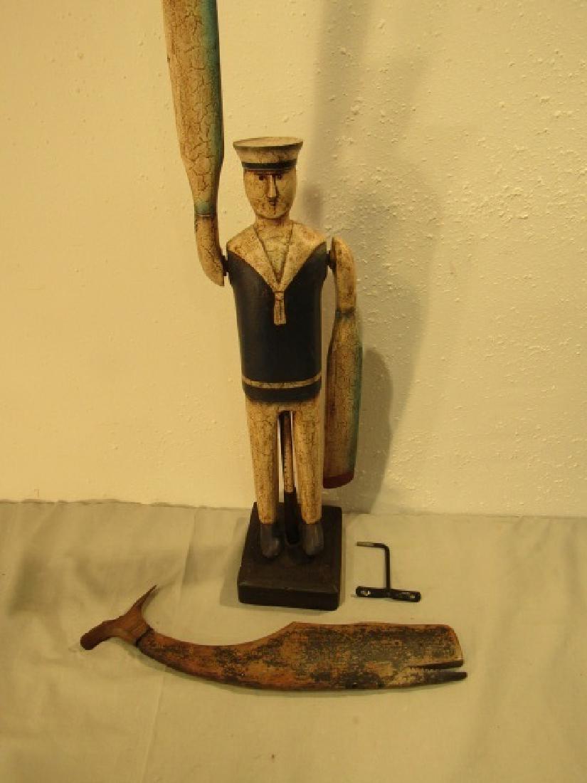 LINCOLN SEELY WHALE WHIRLIGIG & SAILOR: Lot consisting of a Lincoln Macy wood whale whirligig, 20 x 4 inches (worn) and a 33 in tall painted wood sailor whirligig.