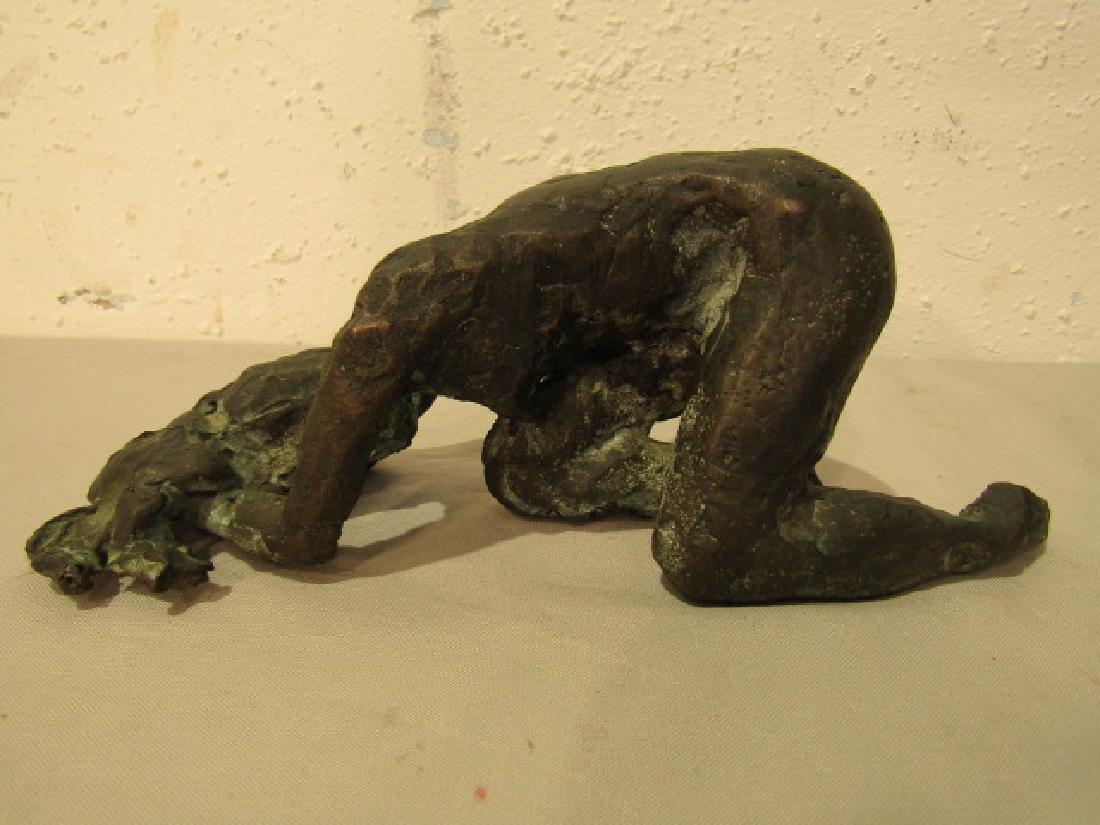 ABSTRACT BRONZE NUDE SCULPTURE: 20th century abstract bronze sculpture of a nude woman with head on floor. 8.5 x 3.5 in high. Unsigned.