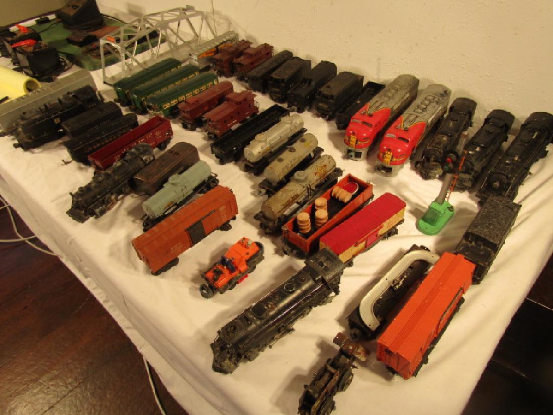 LARGE LOT OLD LIONEL TRAINS: Extensive group of old metal and plastic Lionel trains and cars, about 38 plus accessories. 8 engines including Santa Fe 2343 (as is) & Santa Fe 623, 736, 2037, 2026, 224, 1684 (as is). Cars include 3