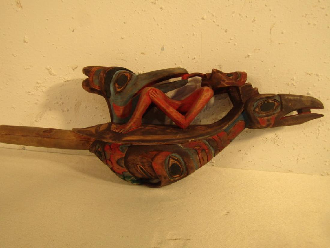 TLINGIT RAVEN RATTLE W/BIRDS: Carved and polychromed figural Tlingit raven rattle with 2 birds and nude man feeding. 17 in long.