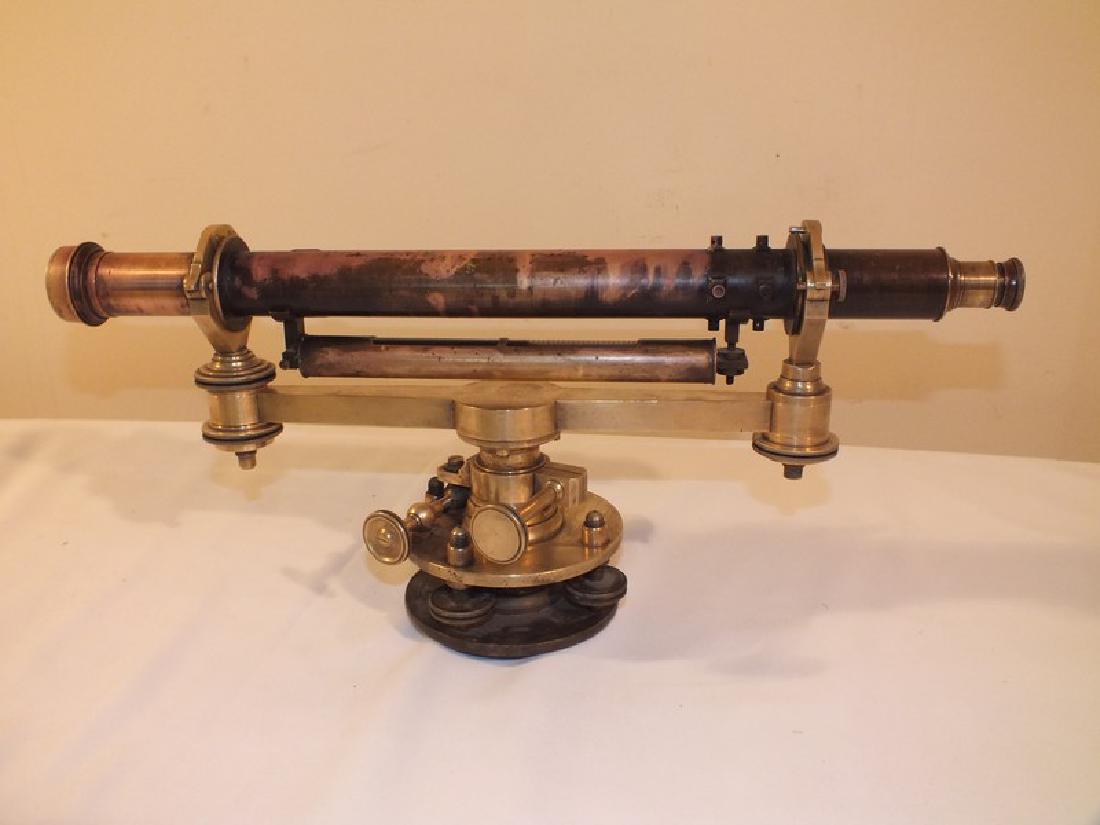 ANTIQUE BRASS TRANSIT - SIGNED NY: Antique heavy brass or bronze transit with level. Lightly engraved Samuel ---NY? 19 inch scope, 8.5 inches high. Good optics, needs further cleaning.