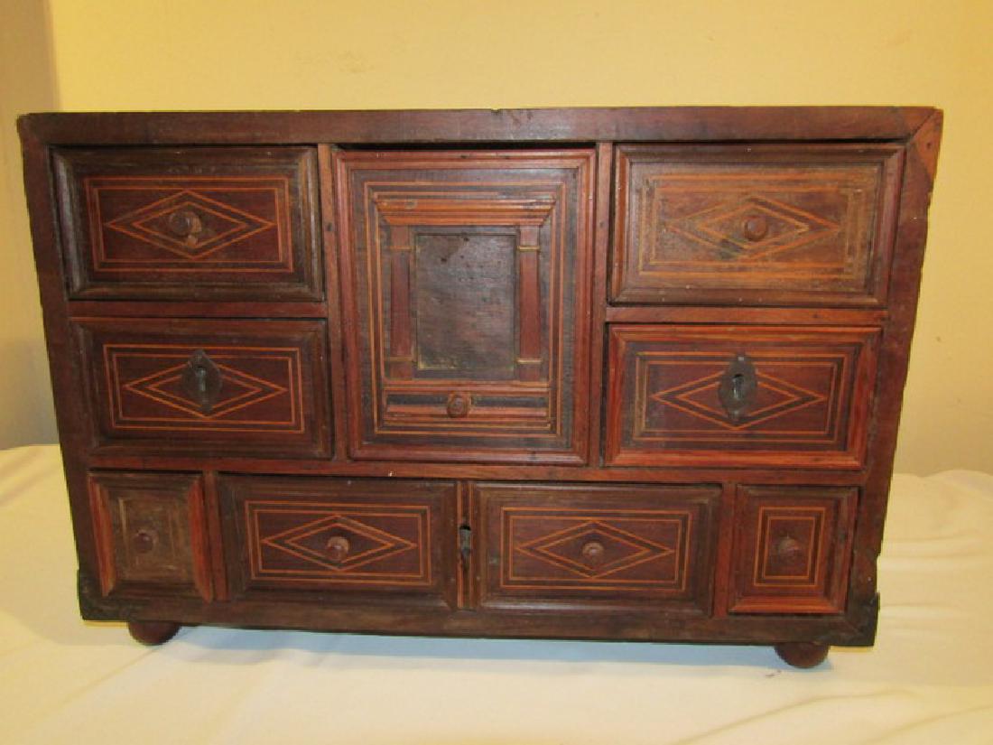 SMALL 18TH CENTURY CABINET: Small 18th century Continental 8 drawer wooden chest or cabinet with line inlay and secret drawer. 23 x 16 x 10 inches.