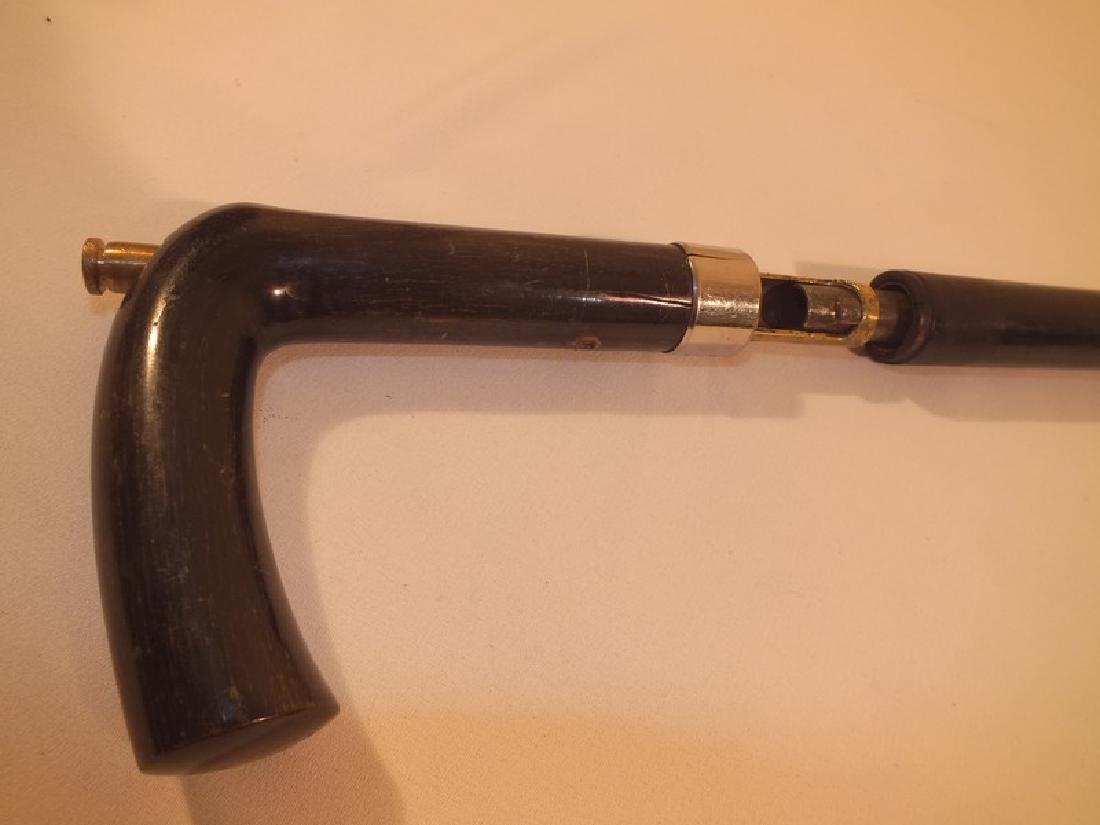 ANTIQUE GUN CANE: Antique gun cane, 32 caliber, 35 inches long, ebony shaft, not marked.