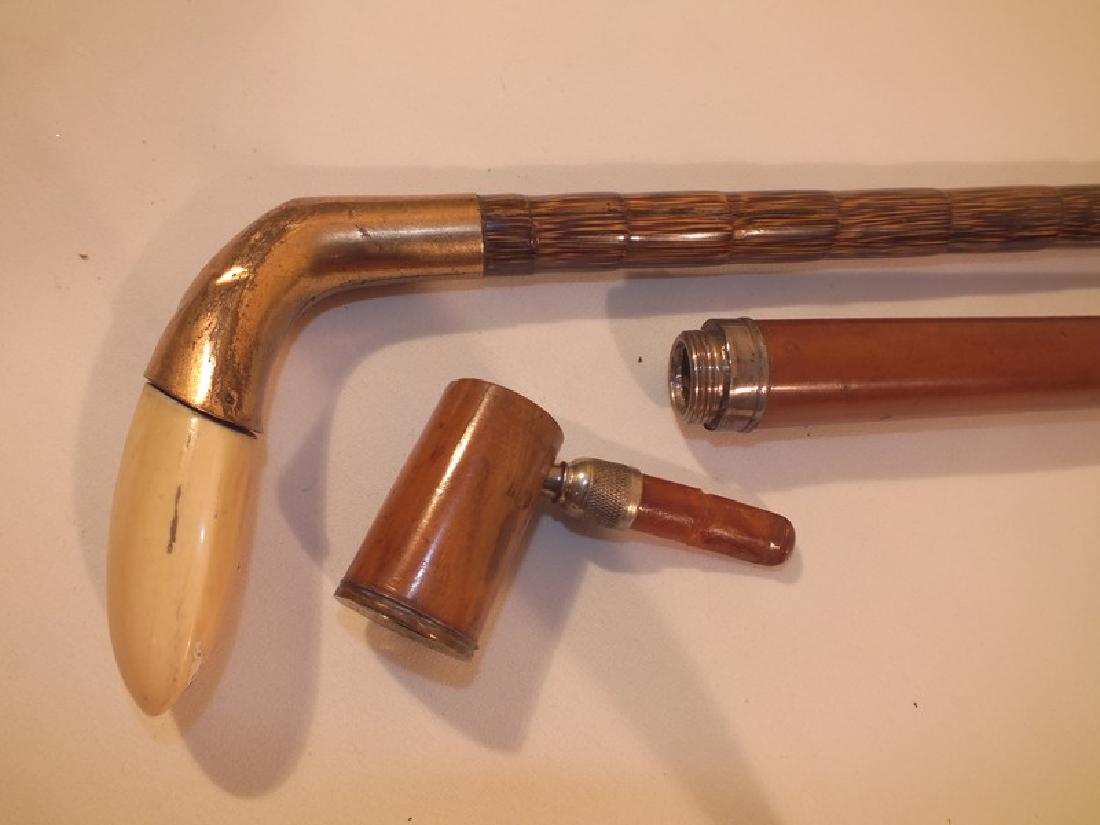 ANTIQUE GOLF & PIPE CANES: 2 antique canes: 34.5 inch cocabola cane with gold club handle in bone and metal; and a 32.5 inch tobacco pipe cane with malacca shaft (repair to amber mouthpiece).